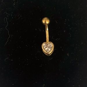 14 solid gold with a heart zirconia covered in a 14 kt gold bezel setting